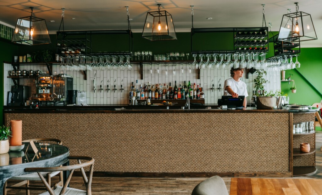 Bar area at Tide House with green tiles and fresh produce display