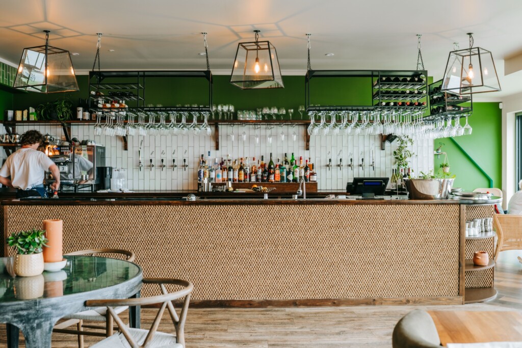 Bar area at Tide House with green tiles and fresh produce display