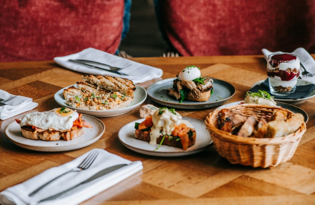 Loaded sourdough breakfast topped with eggs and fresh ingredients at Tidehouse Whitstable